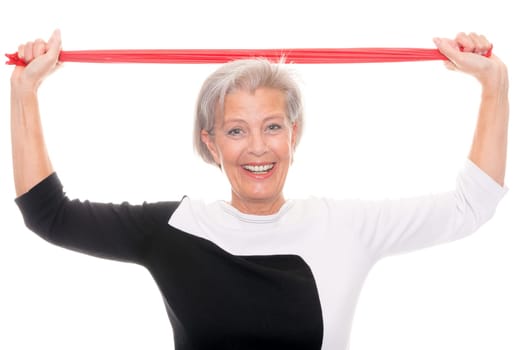 Active senior woman doing sports in front of white background