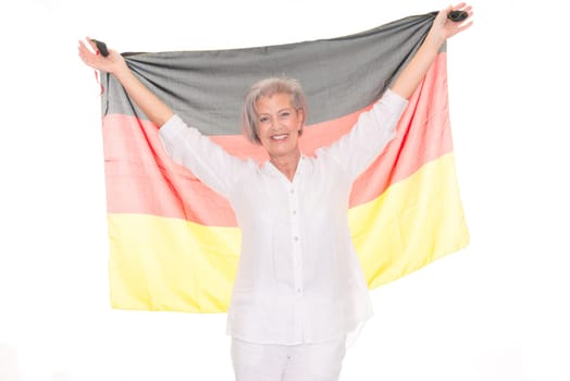 Senior woman as a German football fan in front of white background