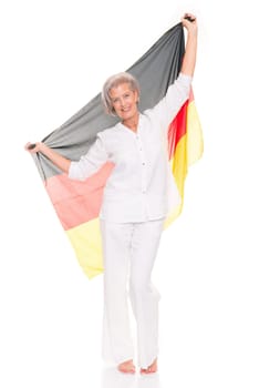 Senior woman as a German football fan in front of white background