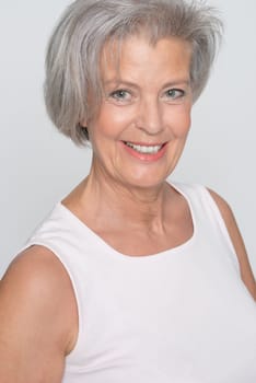 Middle-aged woman in front of gray background