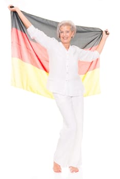 Senior woman as a German football fan in front of white background