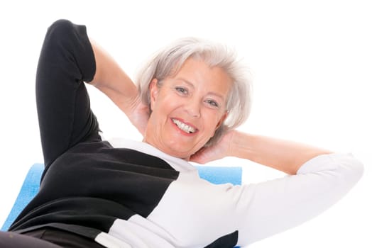 Active senior woman doing sports in front of white background