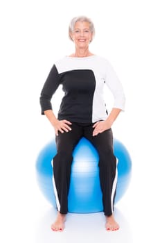 Active senior woman doing sports in front of white background