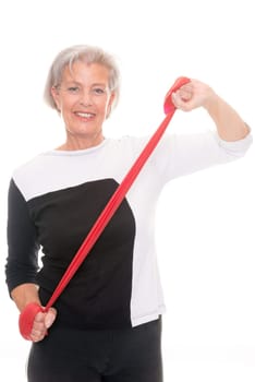Active senior woman doing sports in front of white background