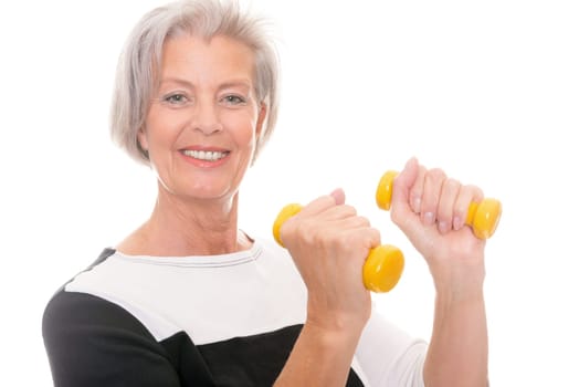 Active senior woman doing sports in front of white background