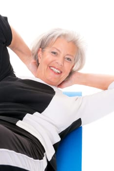 Active senior woman doing sports in front of white background