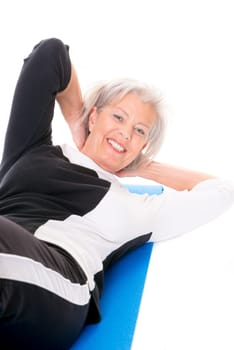 Active senior woman doing sports in front of white background