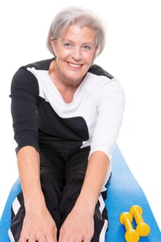 Active senior woman doing sports in front of white background