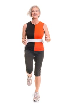 Senior woman doing sports in front of white background