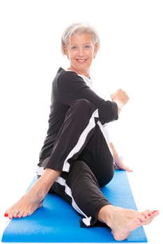 Active senior woman doing sports in front of white background