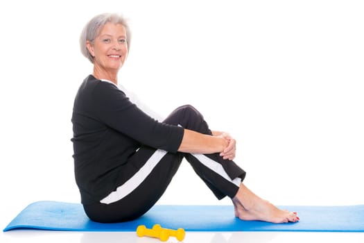 Active senior woman doing sports in front of white background