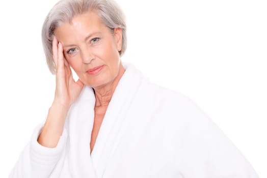 Studio shot of an elderly woman in a white bathrobe
