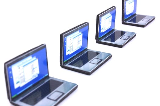 Four mini laptops in a perspective line