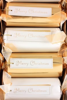 Merry Christmas tags on gold and white crackers