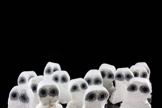 Evil white ghosts in a crowd with black space