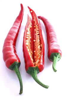 Three red chili's with one cut open