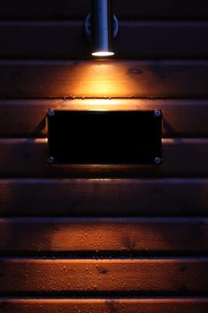 Spotlight on a black empty sign