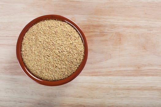 Bowl of wheat germ on wooden surface