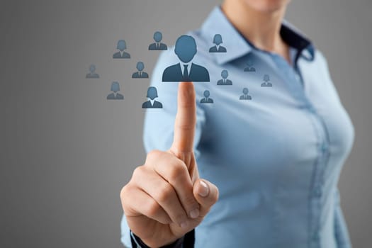 Human resources, CRM and social networking concept - female officer choose person (employee) represented by icon.