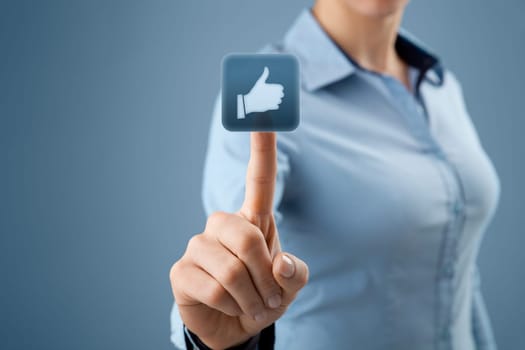 Social network concept. Young woman click on the like button.