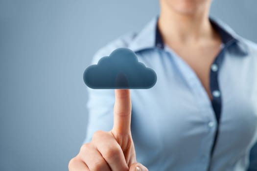 Cloud computing concept. Woman click on cloud icon ahead. Selective focused on finger and cloud.
