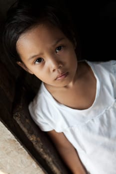 Asian young girl portrait in natural light - Filipina child from impoverished neighborhood in Philippines