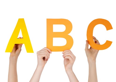 hands hold the letters ABC symbolizing the alphabet, isolated