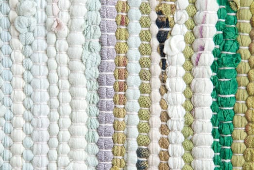 a carpet structured texture in different colors of green and purple