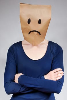 a sad and depressed looking person on gray background