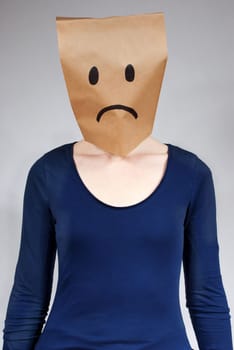 a person symbolizing sadness with gray background