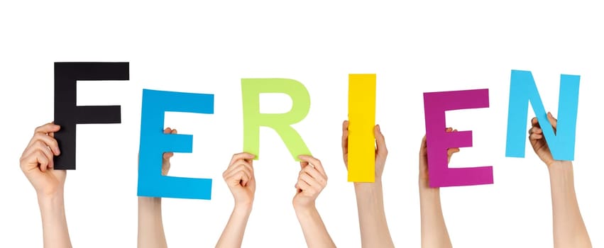 hands holding letters building the german word FERIEN, which means vacations, isolated