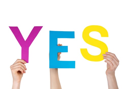 hands holding letters building the word YES, isolated