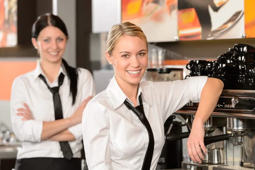 Two waitresses posing in coffee house in uniform