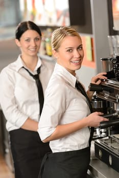 Smiling young waitresses serving coffee in restaurant