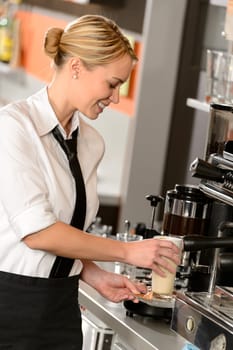 Attractive waitress making coffee with machine in bar