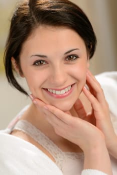 Delighted young woman stroking her face with hands