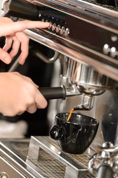 Close up of hands making coffee with espresso machine