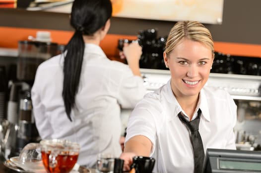 Young happy waitress cashier giving coffee in cafe