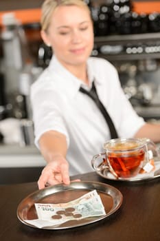 Attractive waitress taking tip in bar from tray czech crowns