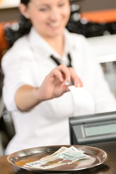 Cash and young cashier giving receipt in bar CZK