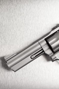 Gun on brushed metal background - a modern revolver.