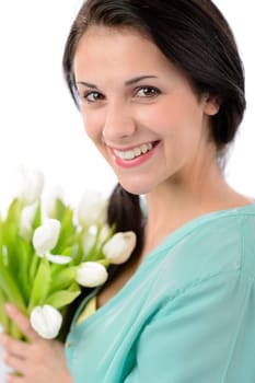 Cheerful young woman with bouquet of white tulips