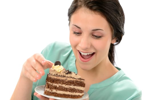 Joyful young girl eating tasty piece of cake