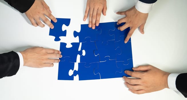 Top view panorama banner of business team assembling jigsaw puzzle over table symbolize business partnership and collective teamwork for HR recruitment and job seeker background. Shrewd