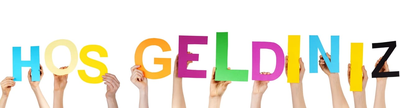 hands hold the turkish word HOS GELDINIZ, which means welcome, isolated