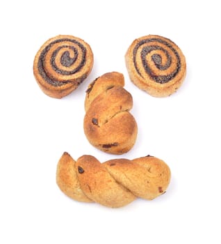 Face made of poppy seed rolls and cranberry braid