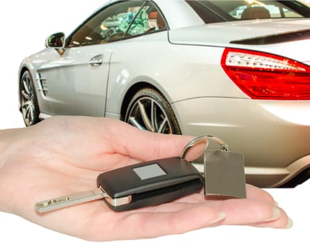 Female hand of owner new car hold a new auto keys with blank nameplate isolated on white
