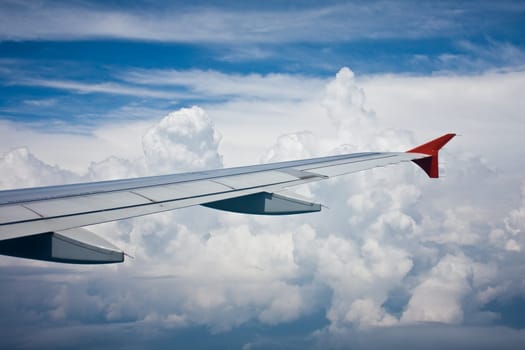 View from the airplane's window on plane's wing and sky