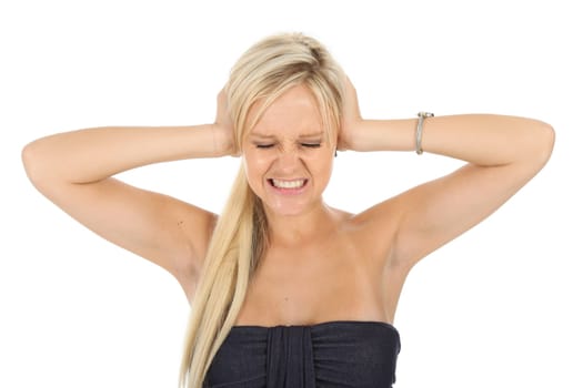 Beautiful young blonde lady blocking her ears and with a pained expression