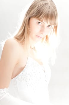 beautiful young bride in white wedding gown and gloves